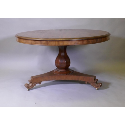 1016 - A C19th mahogany tilt top breakfast table, raised on a shaped column and tri-form platform base with... 