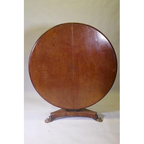 1017 - A Victorian mahogany tilt top breakfast table, with carved column and triform platform base raised o... 