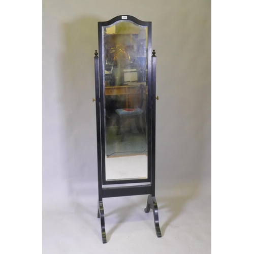 1018 - An ebonised frame cheval mirror with brass mounts and bevelled glass, 50 x 52 x 170cm