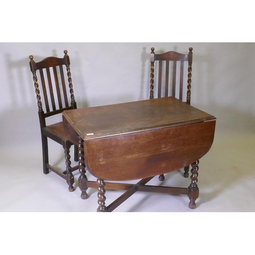 1019 - A Victorian oak drop leaf table, raised on barley twist supports and two chairs, 60 x 91 x 73cm