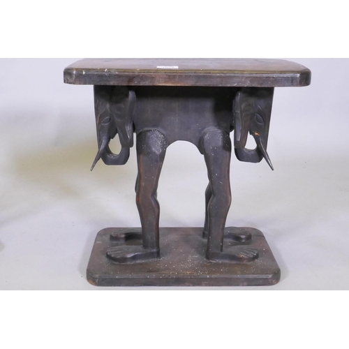 1024 - A pair of antique African carved wood stools, raised on elephant supports, 46 x 27 x 44cm