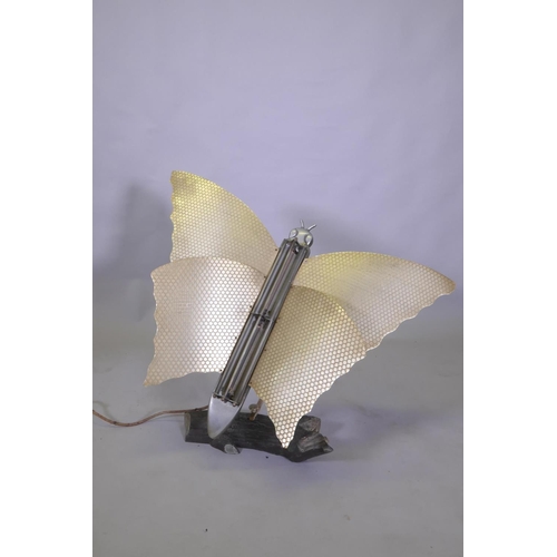 1028 - An Art Deco butterfly room heater, on an aluminium swivel arm, on a naturalistic log base, 77cm high