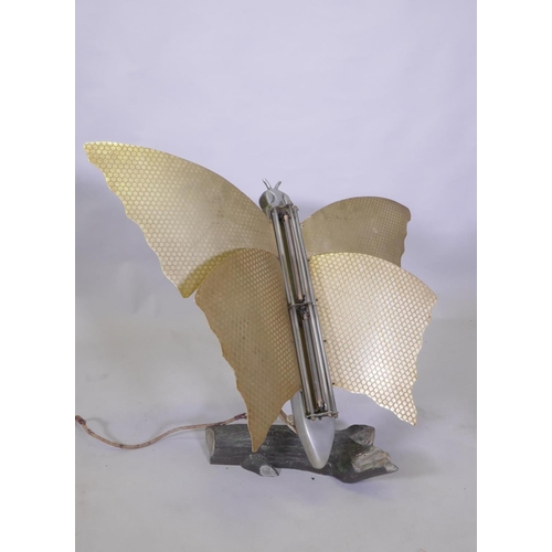 1028 - An Art Deco butterfly room heater, on an aluminium swivel arm, on a naturalistic log base, 77cm high