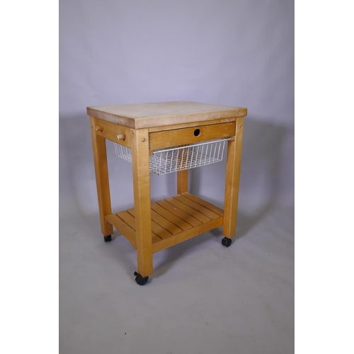 1031 - A beech wood kitchen island with chopping block top, single drawer and pull out basket and slatted u... 