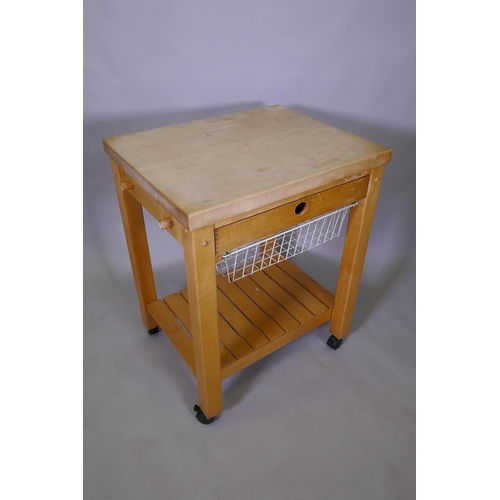 1031 - A beech wood kitchen island with chopping block top, single drawer and pull out basket and slatted u... 