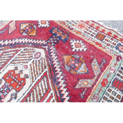 1032 - A red and blue ground flat weave runner, and a Persian red ground wool rug with a cream geometric de... 