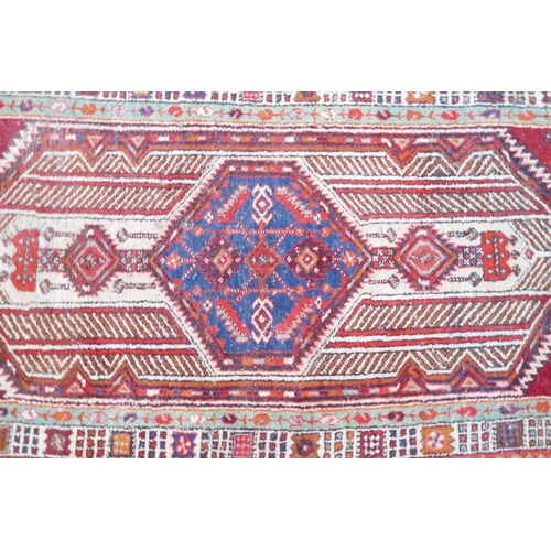 1032 - A red and blue ground flat weave runner, and a Persian red ground wool rug with a cream geometric de... 