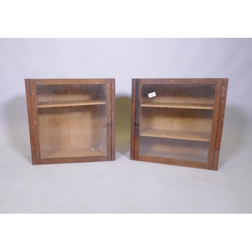 1033 - A pair of oak hanging cabinets with glazed doors and adjustable shelves, 49 x 49 x 20cm