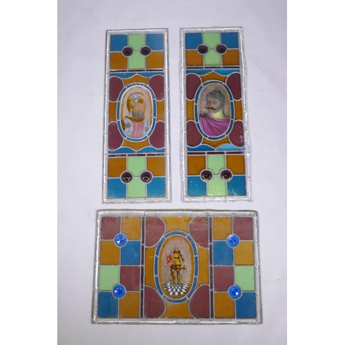 1034 - A pair of antique stained glass windows, and another similar, decorated with knights in armour, pair... 