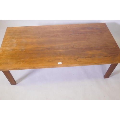 1036 - A mid century rosewood coffee table raised on square supports, 70 x 138 x 45cm