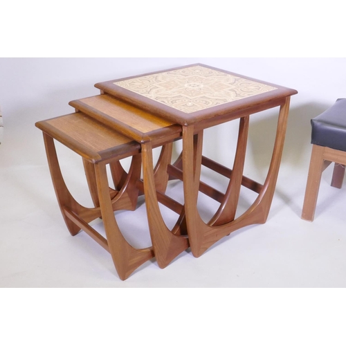 1041 - A nest of three G Plan Astro tile top teak tables, 50 x 50 x 50cm, and a mid century telephone table... 