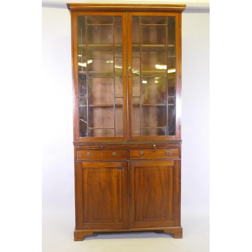 1042 - A George III mahogany bookcase, the upper section with astragal glazed doors and adjustable shelves,... 