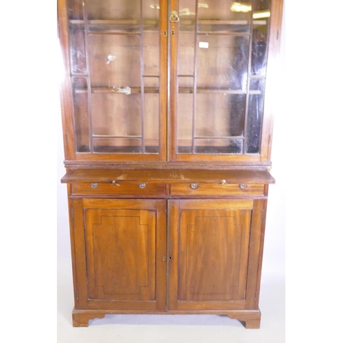 1042 - A George III mahogany bookcase, the upper section with astragal glazed doors and adjustable shelves,... 