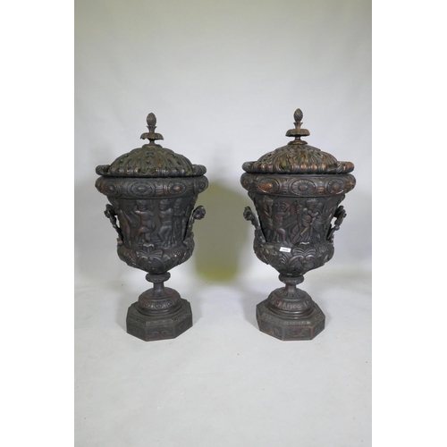 1048 - A pair of carved wood urns and covers with classical style decoration of putti riding a goat, 87cm h... 