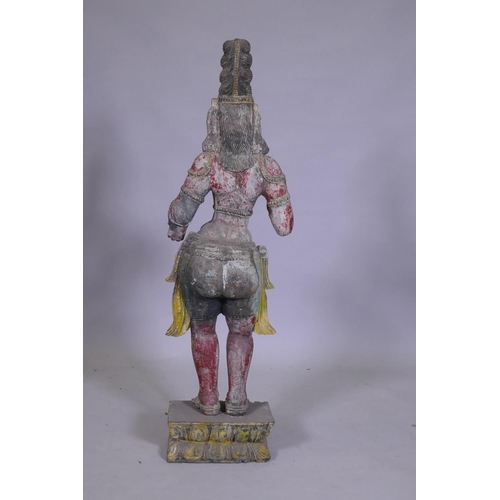 105 - An Indian carved and painted wood Buddhistic figure, 92cm high