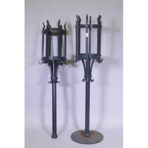 1050 - A pair of painted cast iron torcheres, one lacking base, 140cm high