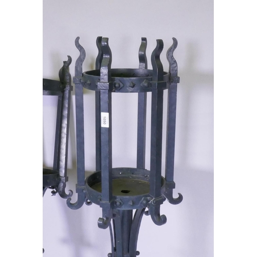 1050 - A pair of painted cast iron torcheres, one lacking base, 140cm high