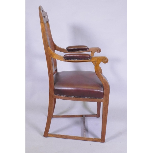 1052 - An Arts & Crafts oak armchair with pierced splat back, studded leather seat and arm rests, and s... 