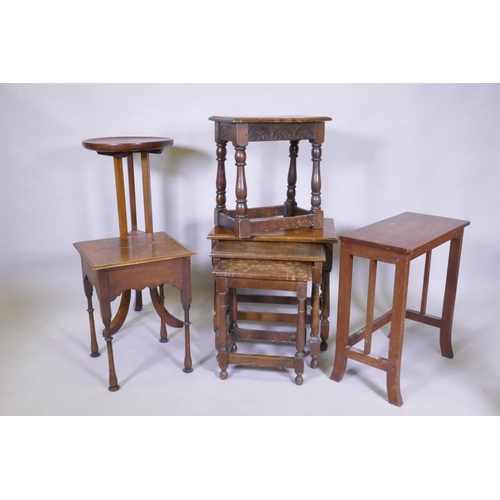 1053 - An Arts & Crafts oak dish top jardiniere stand (reduced), a joynt stool with elm top, nest of th... 