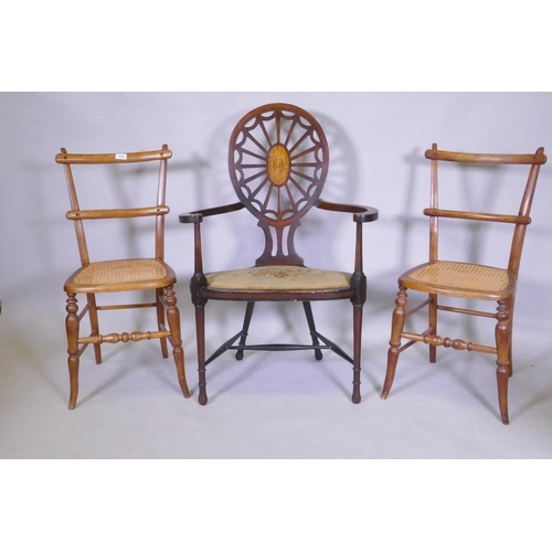 1054 - A Sheraton Revival wheelback arm chair, with satinwood and fan inlay and shaped arms and seat, raise... 