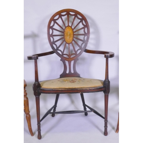 1054 - A Sheraton Revival wheelback arm chair, with satinwood and fan inlay and shaped arms and seat, raise... 