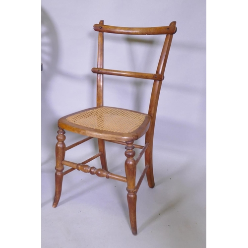 1054 - A Sheraton Revival wheelback arm chair, with satinwood and fan inlay and shaped arms and seat, raise... 