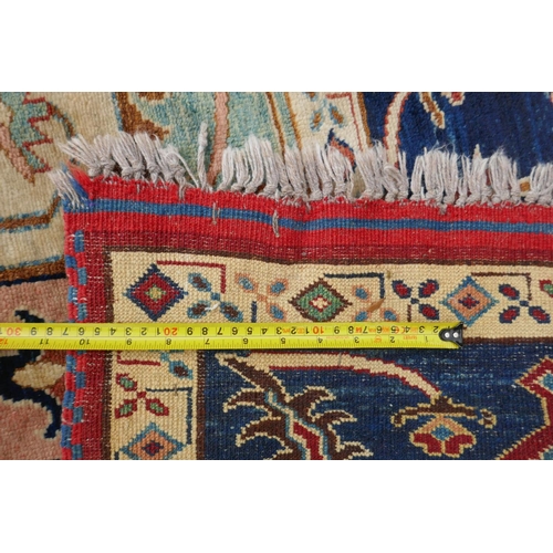 1055 - A Kazak Caucasian multicolour ground wool rug with a central medallion design and blue borders, 224 ... 