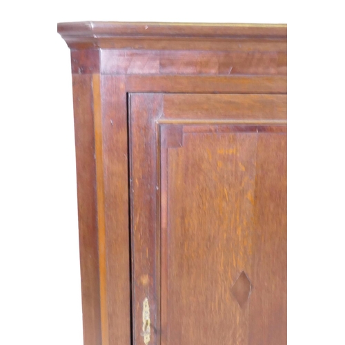 1059 - A Georgian oak hanging corner cupboard, 75 x 99cm