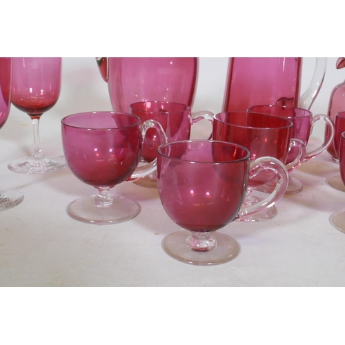 106 - A quantity of Victorian cranberry glass, jugs, drinking glasses and custard cups