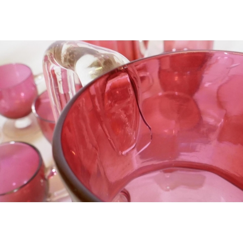 106 - A quantity of Victorian cranberry glass, jugs, drinking glasses and custard cups