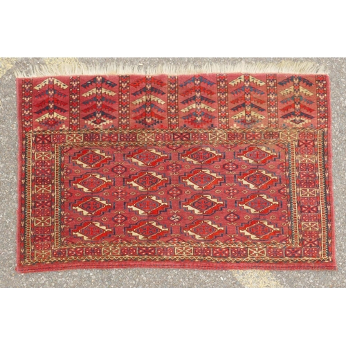 1060 - A rust ground Jibal Bokhara rug, 110 x 70cm