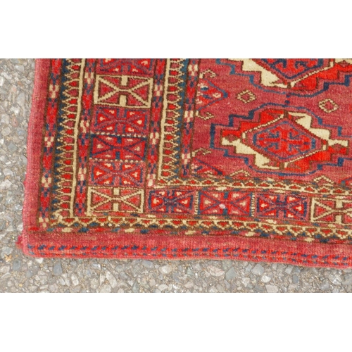 1060 - A rust ground Jibal Bokhara rug, 110 x 70cm