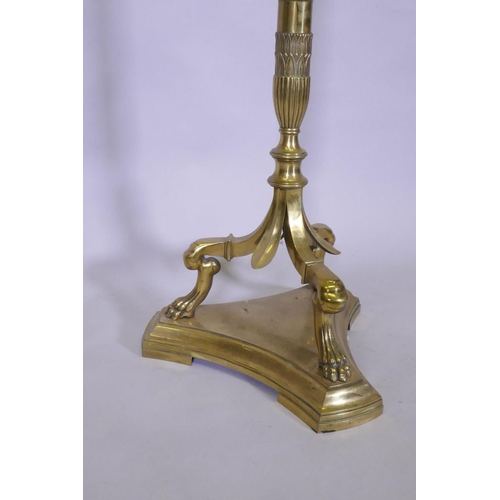 1062 - A brass floor lamp with three branches and fluted column, raised on three paw supports, 142cm high