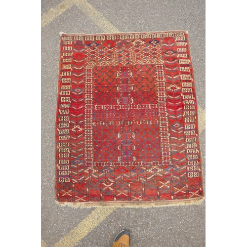 1065 - A rust ground Turkmen Bokhara rug, 115 x 140cm