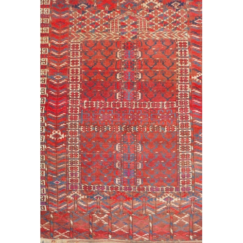 1065 - A rust ground Turkmen Bokhara rug, 115 x 140cm