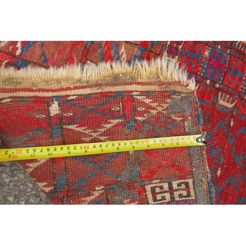 1065 - A rust ground Turkmen Bokhara rug, 115 x 140cm