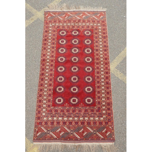 1085 - A red ground Turkmen Bokhara runner, 222 x 110cm