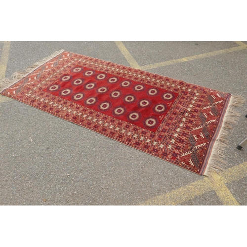 1085 - A red ground Turkmen Bokhara runner, 222 x 110cm