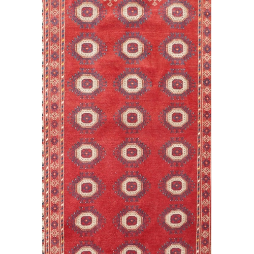 1085 - A red ground Turkmen Bokhara runner, 222 x 110cm