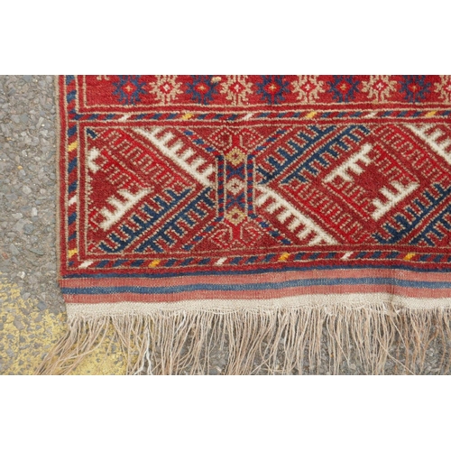 1085 - A red ground Turkmen Bokhara runner, 222 x 110cm