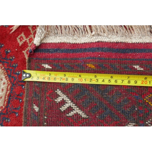 1085 - A red ground Turkmen Bokhara runner, 222 x 110cm