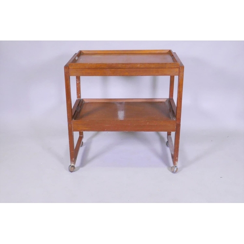 1087 - A mid century White & Newton teak two tier trolley in two sections with removable galleried tray... 