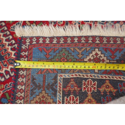 1089 - A south Persian Ghashgai red ground wool runner, decorated with a string of medallions, birds and fl... 