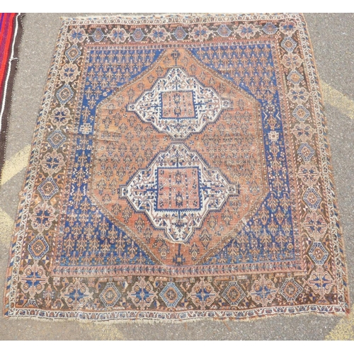 1094 - An antique Persian rust ground wool Hamadan rug with two cream ground geometric medallions, AF, 150 ... 