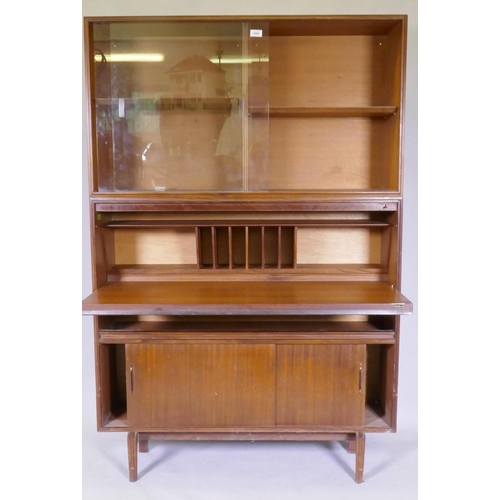 1096 - A mid century Beaver & Tapley Ltd multi width teak unit in two sections, the upper with sliding ... 