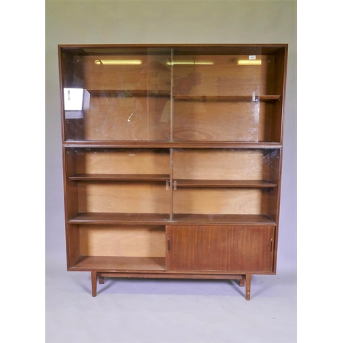 1097 - A mid century Beaver & Tapley Ltd multi width teak bookcase unit in two sections, with glass and... 