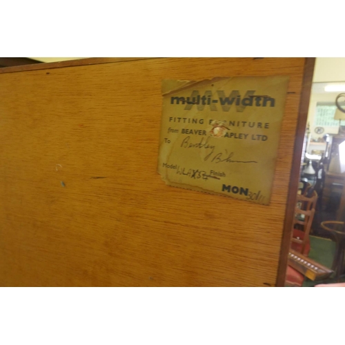 1097 - A mid century Beaver & Tapley Ltd multi width teak bookcase unit in two sections, with glass and... 