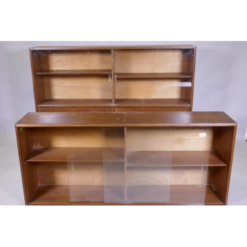 1097 - A mid century Beaver & Tapley Ltd multi width teak bookcase unit in two sections, with glass and... 