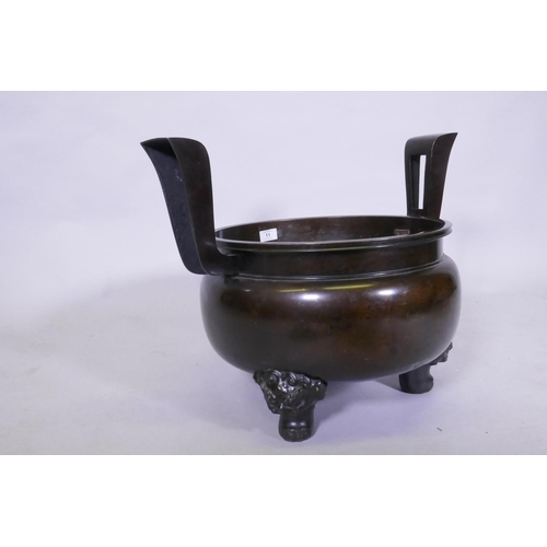 11 - A large Japanese bronze censer, raised on tripod supports, AF detached, bowl 40cm diameter, 47cm hig... 