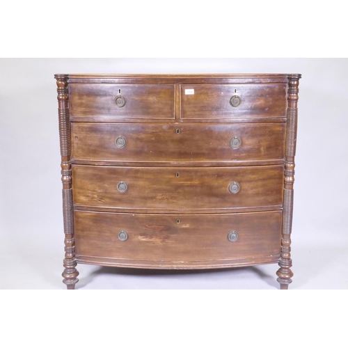 1104 - A good Regency mahogany bowfront chest of four long drawers, with cockbeaded detail and brass ring h... 